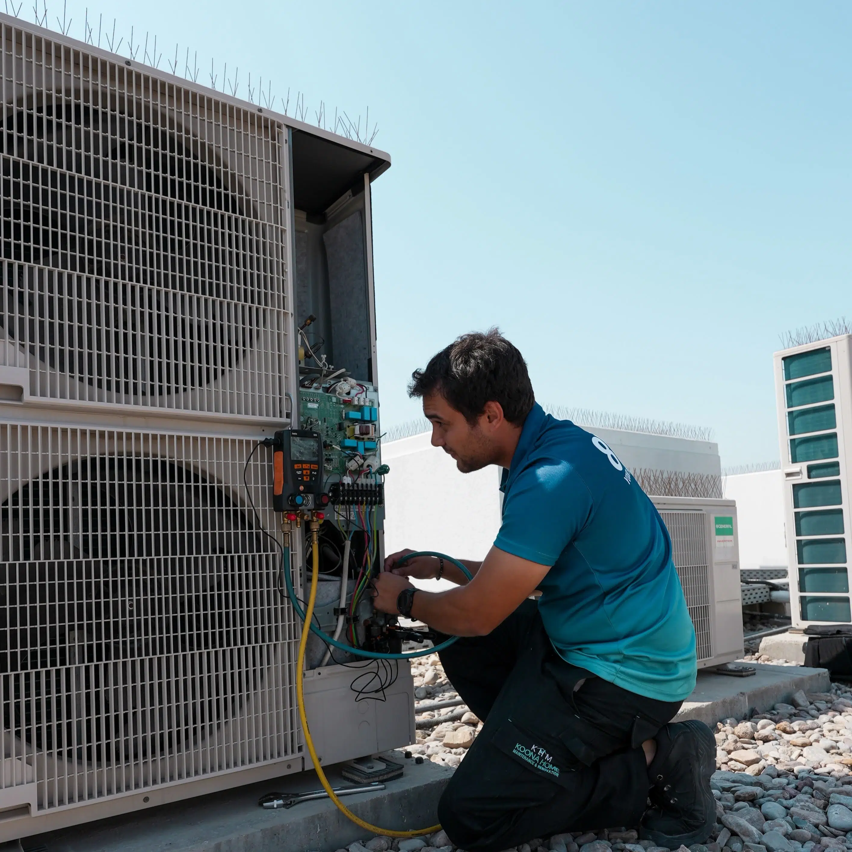 Technician performing AC replacement and inspecting an outdoor air conditioning unit on a rooftop setup.